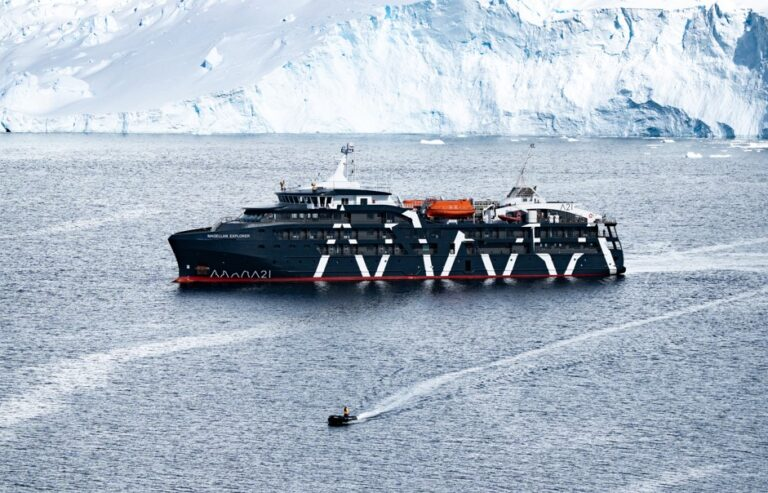 Antarctica21 Magellan Explorer fly-cruise ship near glacier